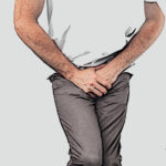 Picture of man suffering from full bladder and clenching his legs.